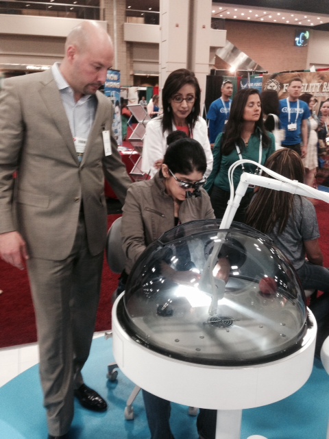 Dr. Fantarella stands alongside a dentist as she demos Solea on an extracted tooth. 